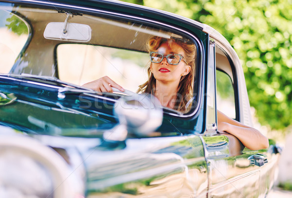 Beautiful woman sitting in a car. Retro styled Stock photo © amok