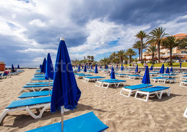 Sunbeds and parasols on the Los Cristianos beach, the most popular and well-known resort in Tenerife Stock photo © amok
