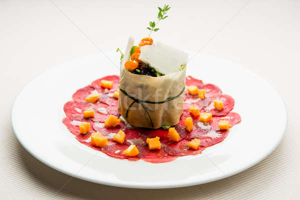 Venison carpaccio with sea buckthorn marmalade and sprout salad Stock photo © amok