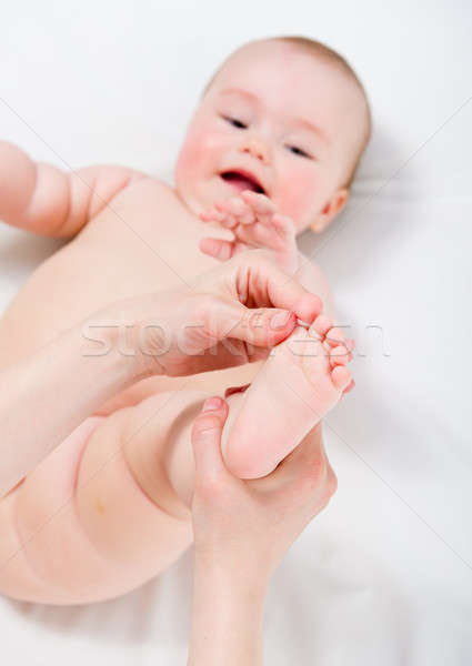 Mother massaging her baby girl Stock photo © amok