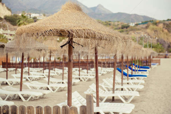 Parasols and empty deckchairs on the Nerja beach.  Spain Stock photo © amok
