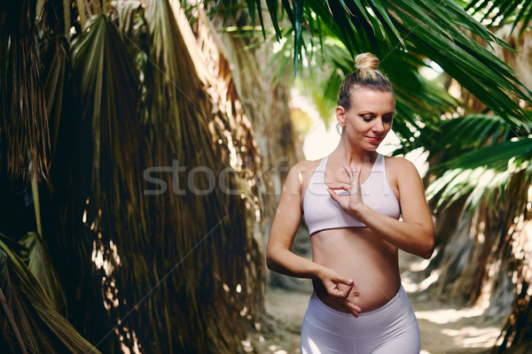 Pregnant woman in sportswear in tropical nature Stock photo © amok