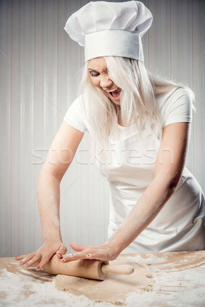 Angry and stressed out woman cook rolling dough Stock photo © amok