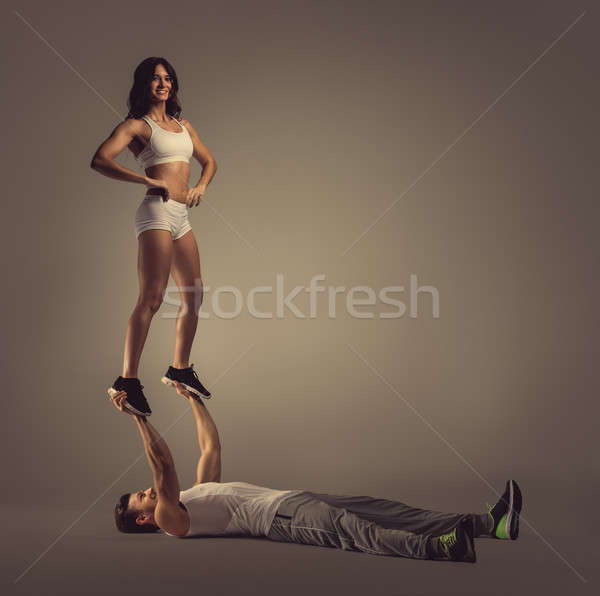 Athletic couple doing acro yoga, studio shot Stock photo © amok