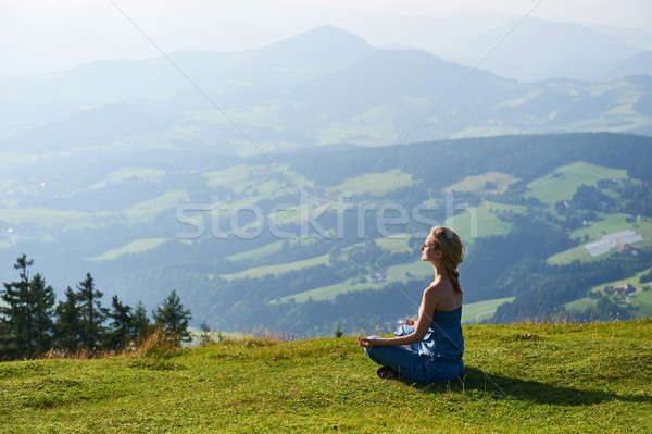 Young woman practice yoga on mountain peak Stock photo © amok