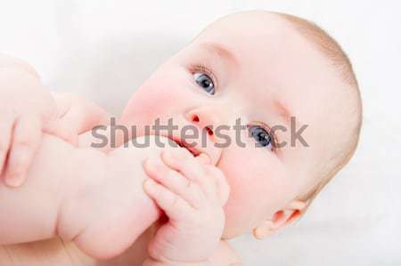 Adorable baby sucking his toe Stock photo © amok