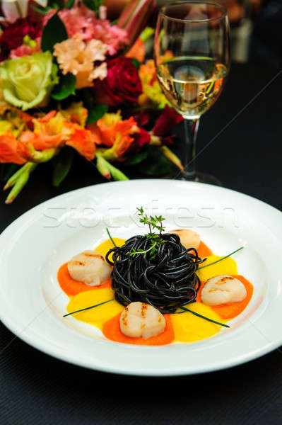 Black pasta with meat, garnished with sauce and  herbs close-up Stock photo © amok