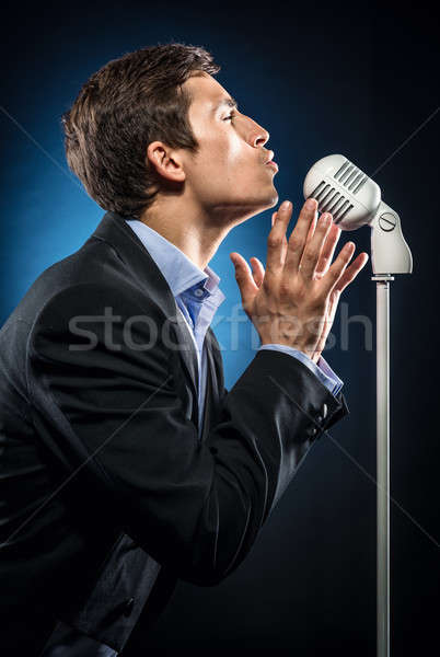 Man in elegant black jacket and blue shirt singing Stock photo © amok