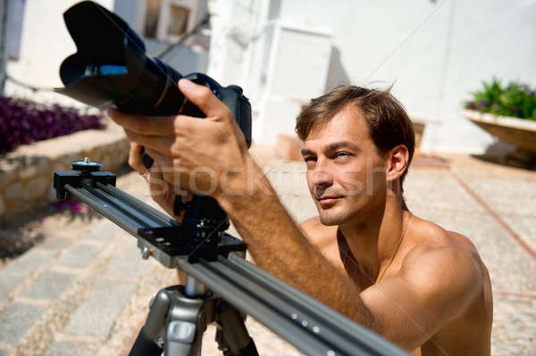Handsome man with camcorder outdoors Stock photo © amok