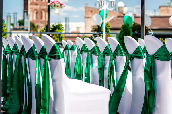 White wedding chairs with green ribbon outdoors Stock photo © amok