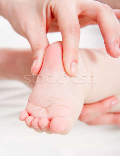 Mother massaging her baby Stock photo © amok