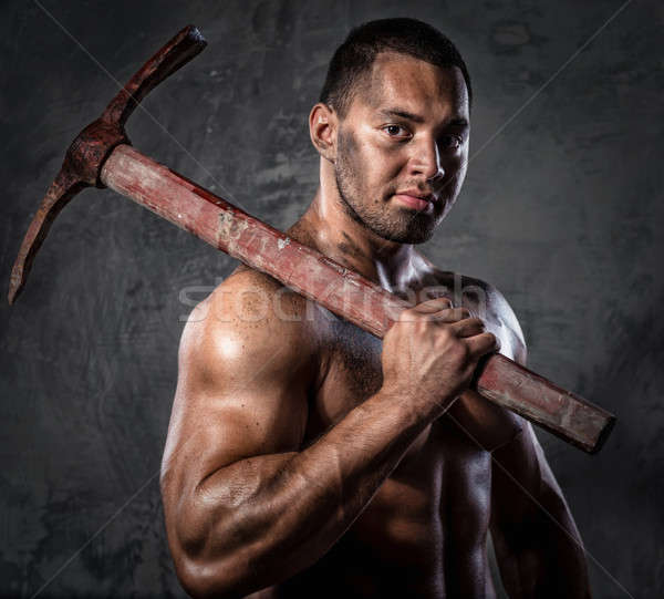Muscular man holding pickaxe Stock photo © amok