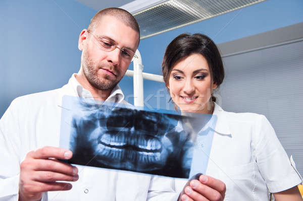 Stock photo: Dentist and assistant checking x-ray at dental clinic