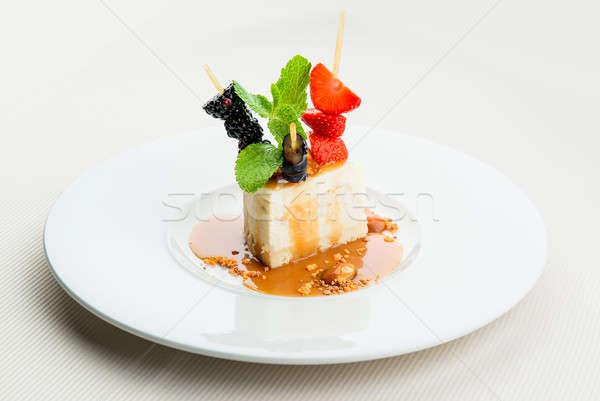 Delicious cheesecake and fresh berries on white plate Stock photo © amok