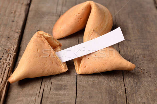 Cracked fortune cookie on a wooden table Stock photo © andreasberheide