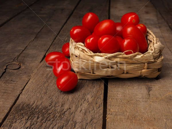 Organic grape tomatoes on a wooden table Stock photo © andreasberheide