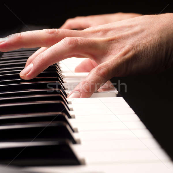 Stock photo: Playing piano close up