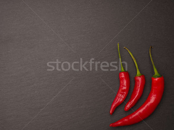 Red pepperoni on a dark slate background Stock photo © andreasberheide