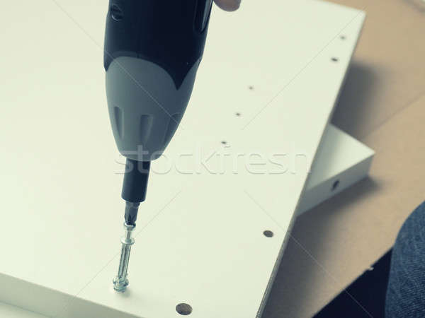Assembling furniture with cordless screwdriver Stock photo © andreasberheide