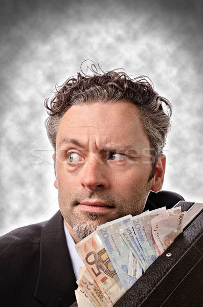 Pénzkeresés üzletember bőrönd pénz férfi öltöny Stock fotó © andreasberheide