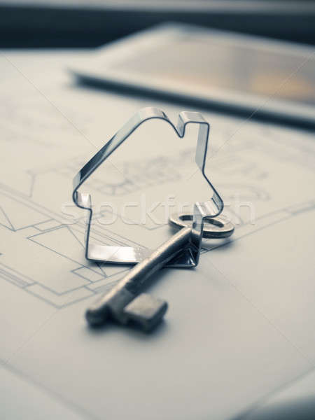 House shape with a key on construction plan Stock photo © andreasberheide