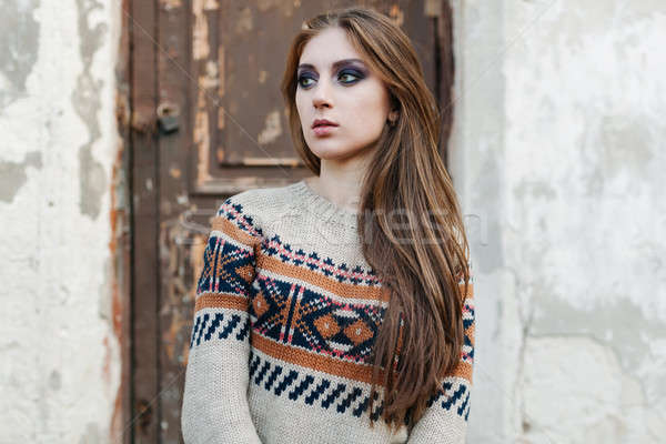 Beautiful Woman with long hair in winter pullover. Healthy hair. Grey background Stock photo © andreonegin