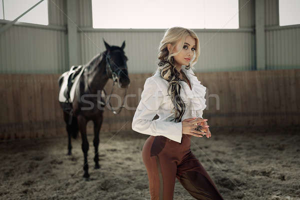 Beautiful elegant young blonde girl standing near her horse dressing uniform competition Stock photo © andreonegin
