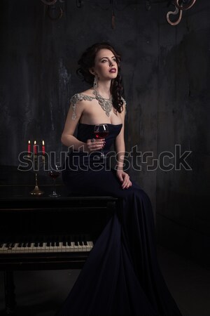 Belo mulher jovem vestido preto piano velas vinho Foto stock © andreonegin