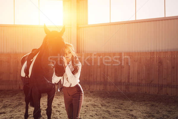 Beautiful elegant young blonde girl standing near her horse dressing uniform competition Stock photo © andreonegin