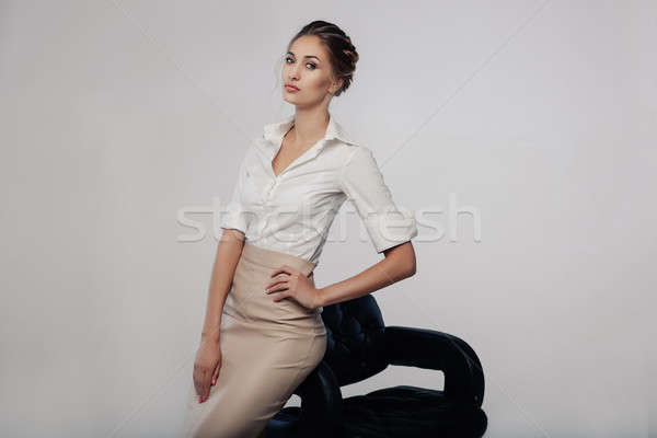 Beautiful elegant young bussines woman standing on the studio with gray background Stock photo © andreonegin