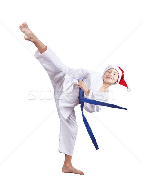 Boy in a cap of Santa Claus beats a high kick leg Stock photo © Andreyfire