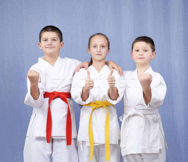 Boy and girl standing in rack of karate and showing the finger super Stock photo © Andreyfire