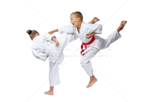 On a white background sportsmens are beating blows karate Stock photo © Andreyfire