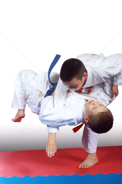Two athletes in judogi are doing throws Stock photo © Andreyfire