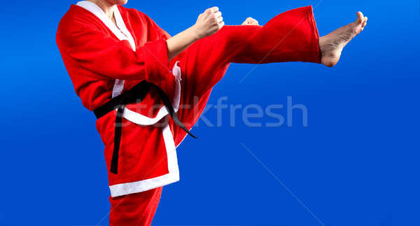 Stock photo: In cloth Santa Claus athlete beats kicking