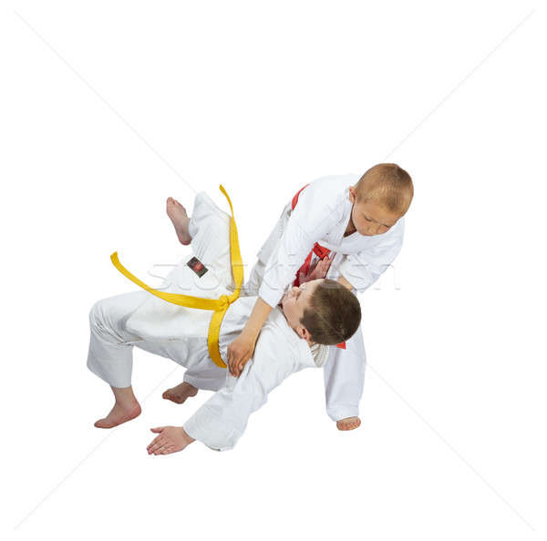 Sportsman with a red belt throws athlete with yellow belt Stock photo © Andreyfire