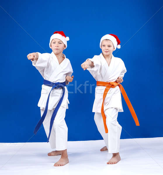 Two athletes in caps of Santa Claus beats punch hand Stock photo © Andreyfire