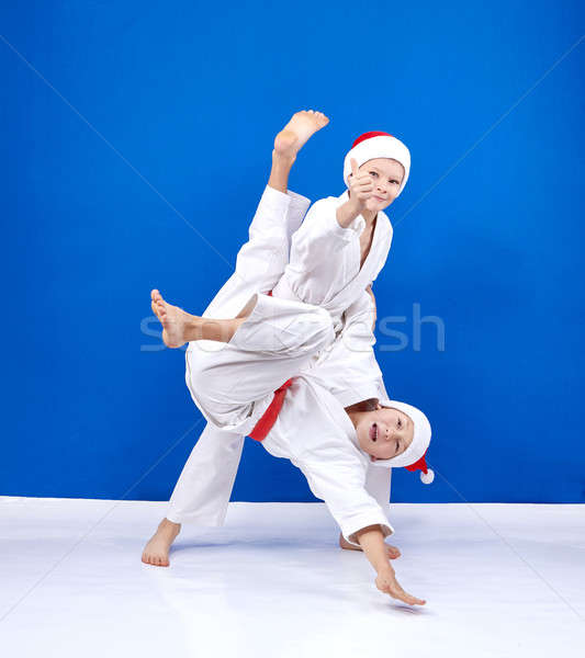 Young athletes in cap of Santa Claus are training throws Stock photo © Andreyfire