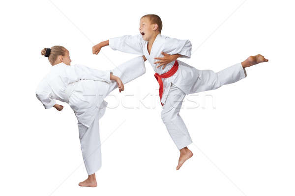 Gyaku-tsuki and mavashi geri are beating sportsmens in karategi Stock photo © Andreyfire