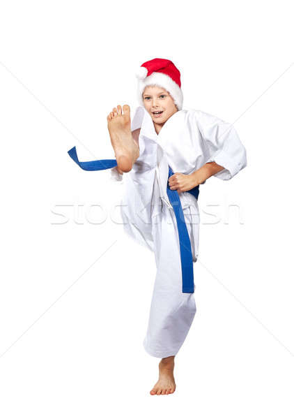 Boy in a cap of Santa Claus hits a kick leg Stock photo © Andreyfire