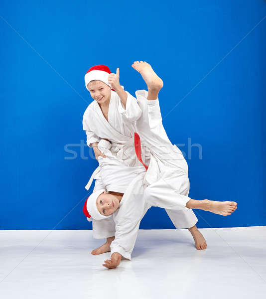 Two athletes in caps of Santa Claus are training throws Stock photo © Andreyfire