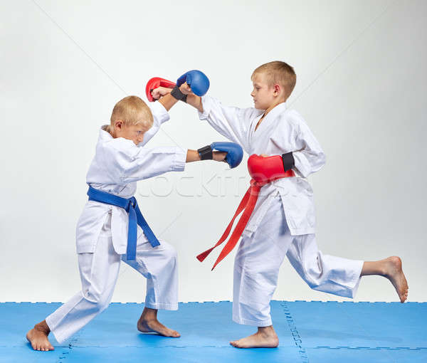 Paired exercise of karate are training athletes with overlays on his hands Stock photo © Andreyfire