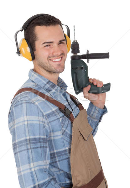 Worker holding drill and wearing hard hat Stock photo © AndreyPopov