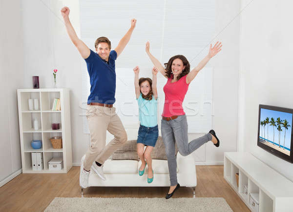 Portrait Of Excited Family Jumping At Home Stock photo © AndreyPopov