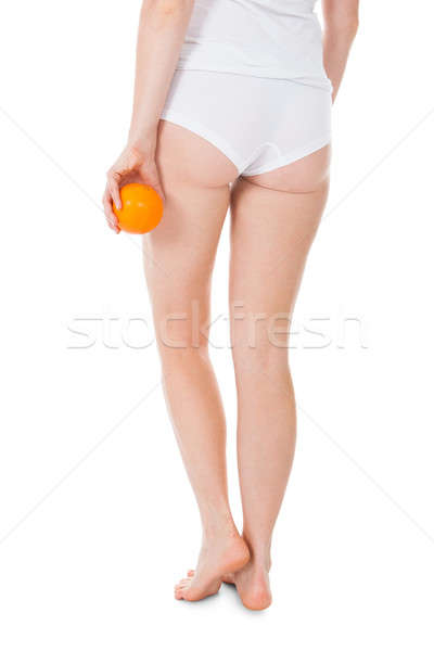 Low Section Of Woman Holding Orange Stock photo © AndreyPopov