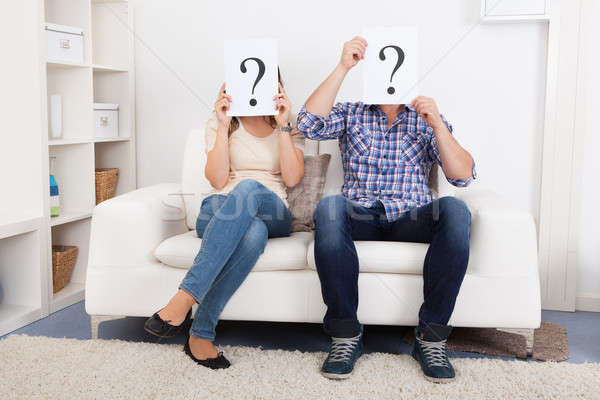 Couple Holding Question Mark Sign In Front Of Face Stock photo © AndreyPopov