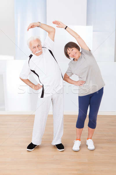 Senior Couple Doing Stretching Exercise Stock photo © AndreyPopov