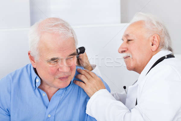 Doctor Examining Senior Man's Ear With Otoscope Stock photo © AndreyPopov