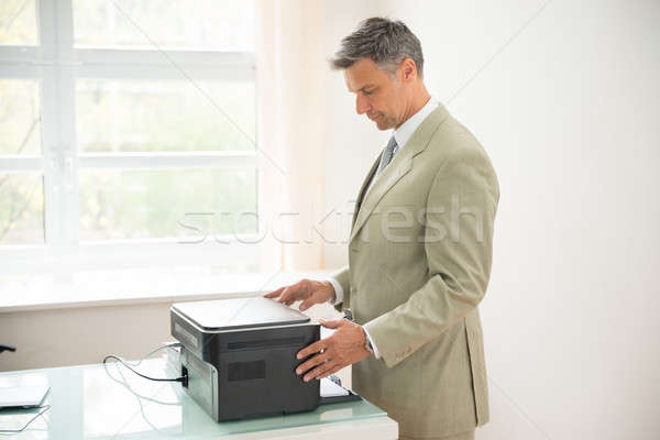 Businessman Using Photocopy Machine Stock photo © AndreyPopov