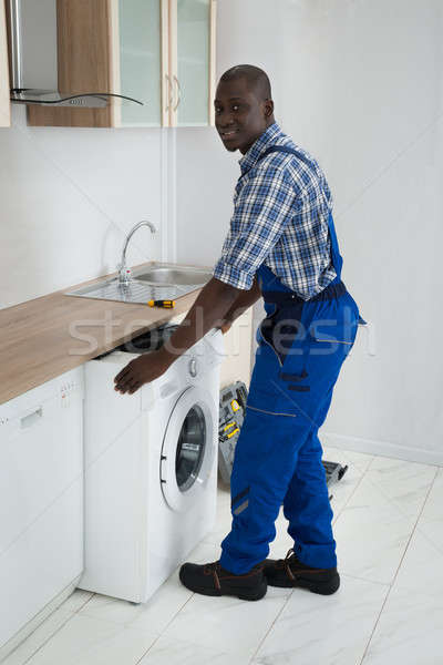 Technicien machine à laver cuisine jeunes africaine Homme [[stock_photo]] © AndreyPopov